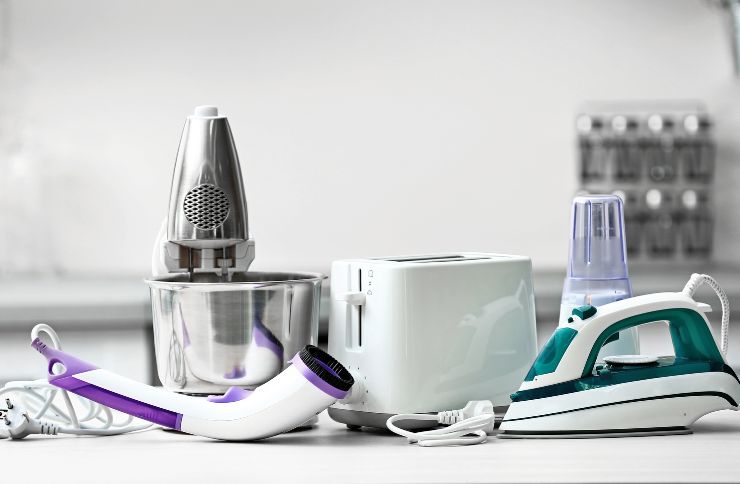 An assortment of kitchen appliances, featuring a blender and an iron, showcasing a small appliance repair service in Houston, TX.